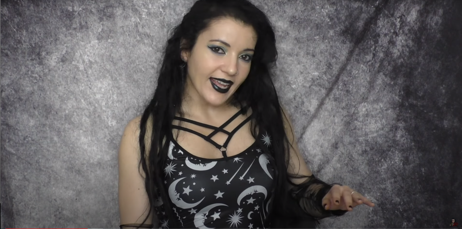Angela Puca wearing a moon and stars black top with strapes shaped as a pentagram
