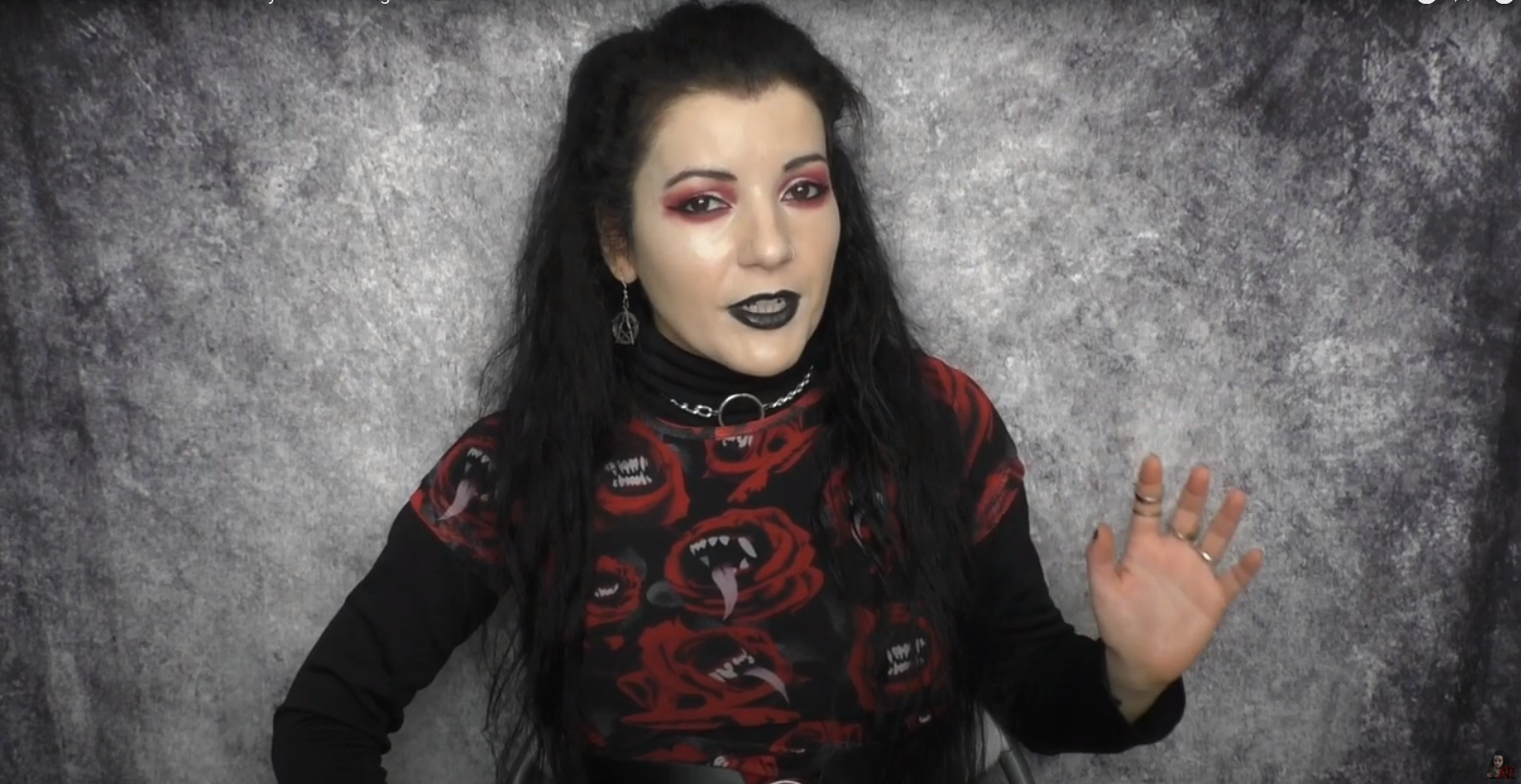 Angela Puca wearing a black shirt decorated with red demons