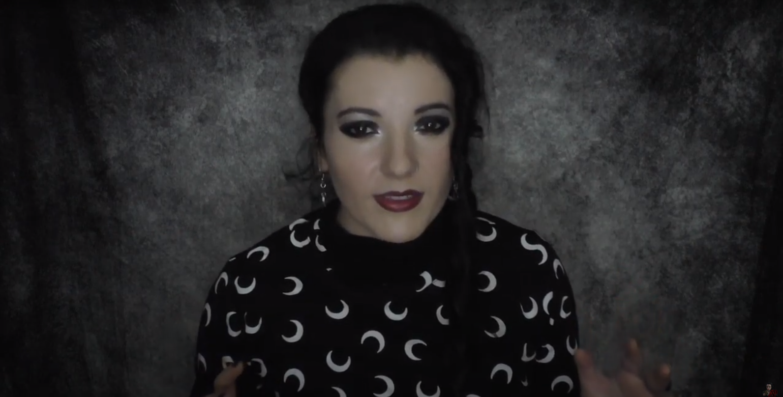 Angela Puca wearing a black shirt covered in crescent moons.