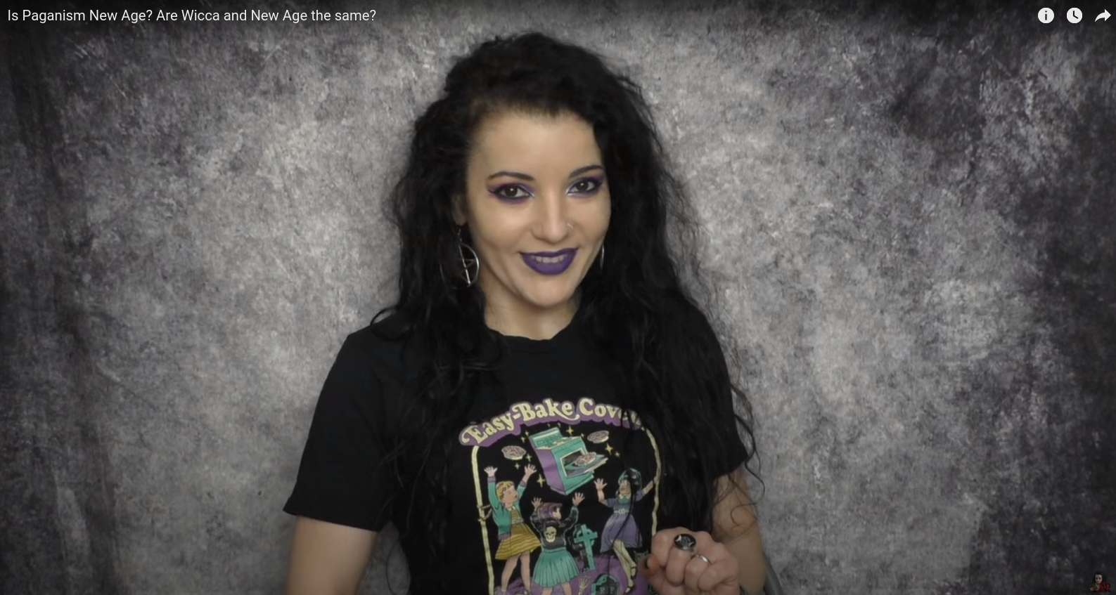 Angela Puca wearing a black T-shirt with the words "Easy Bake Coven" and a cartoon