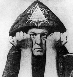 Aleister Crowley with hands against his cheeks PD