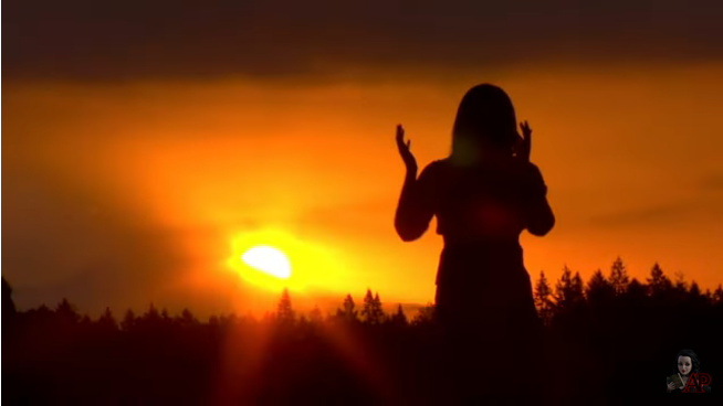 screenshot - a woman worshipping the setting sun