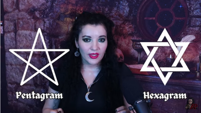 Screenshot - Dr Puca with a pentagram and hexagram depicted either side of her.