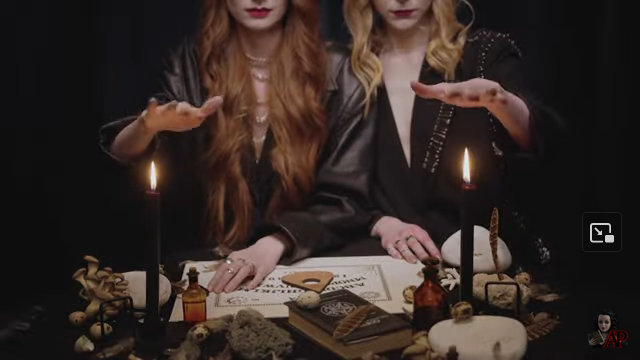 screen shot two witches with candles 